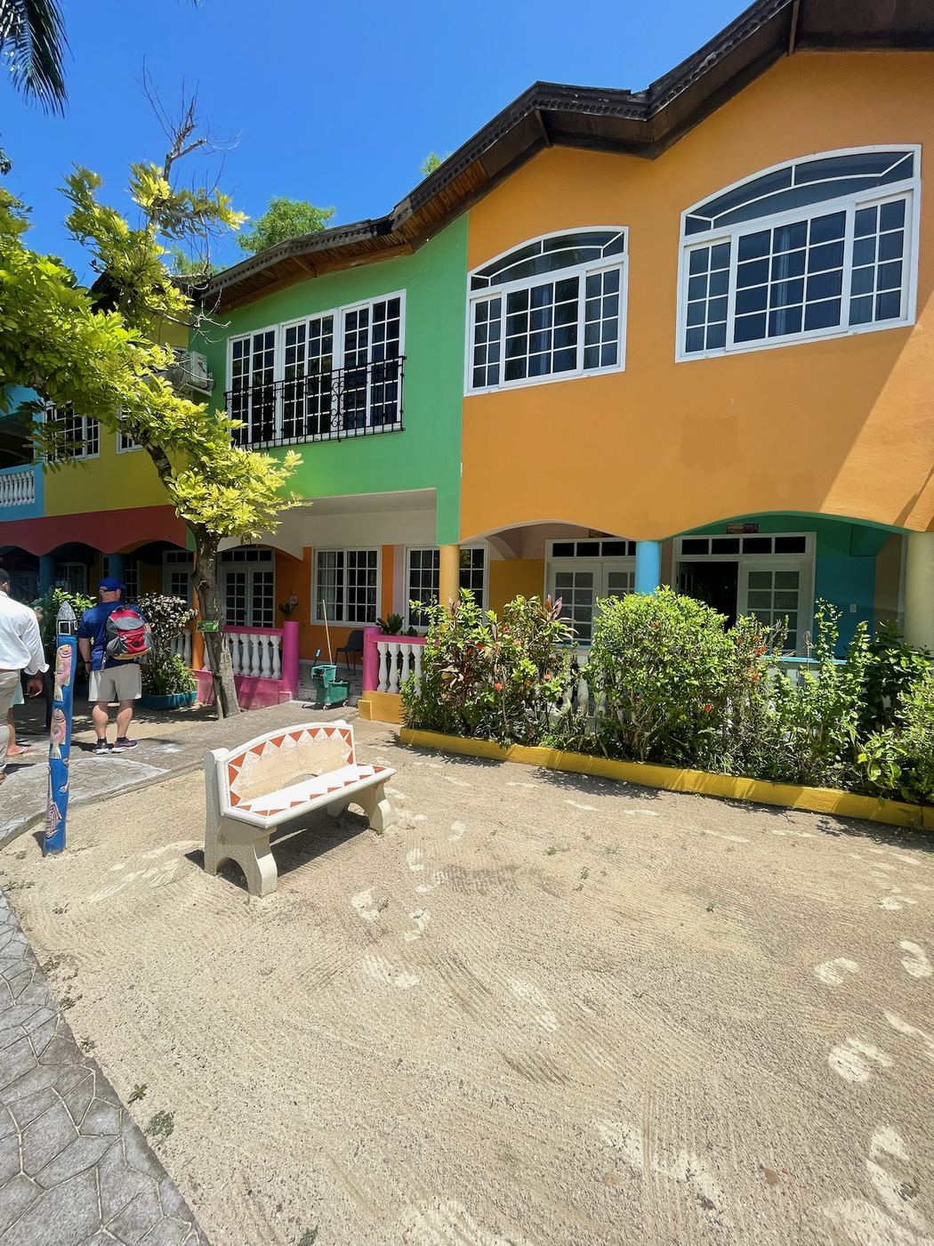 Brightly painted houses along a sandy lane in Jamaica