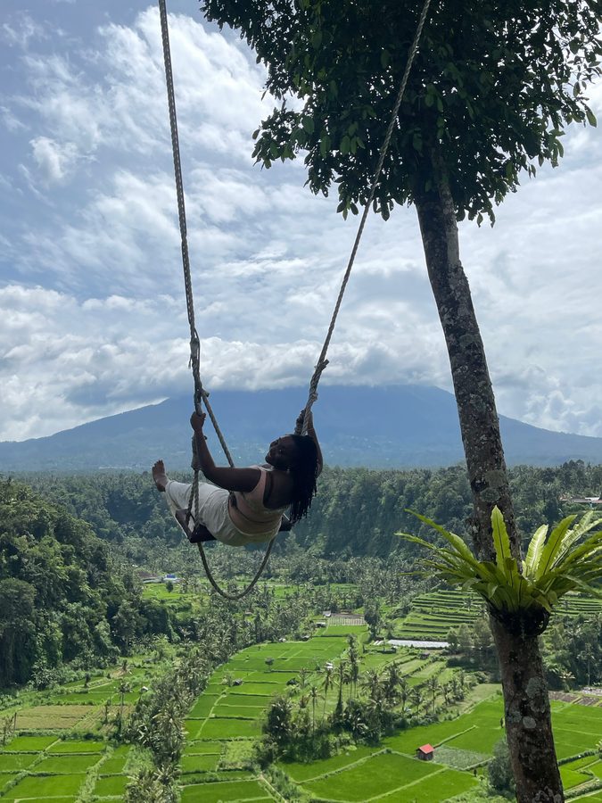 Ashleigh on a rope swing above rice terraces