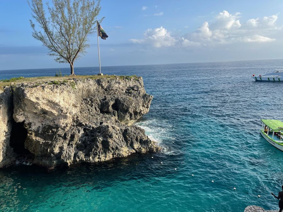 Cliffs and small boats above turquoise water