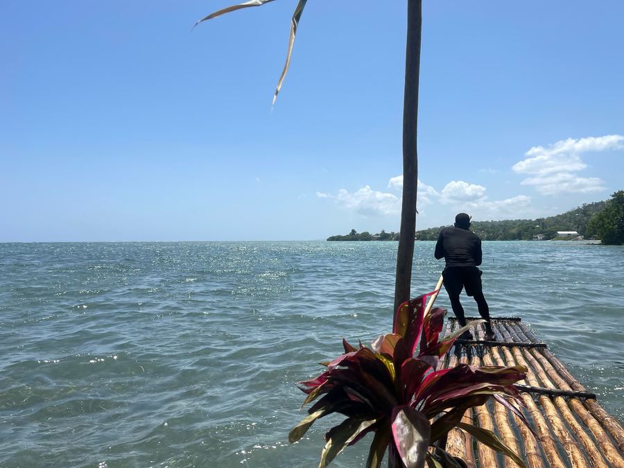 A bamboo raft heading out over open water